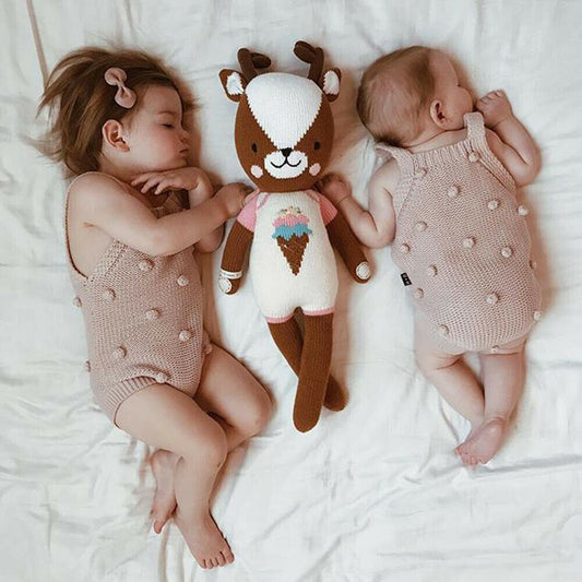 two babies in our knitted newborn onesies